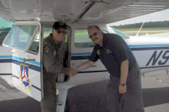 Col Crawford congratulates Lt Col Wally Courtney on his 250th Cadet Orientation flight.