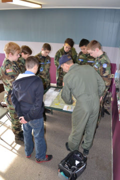 Cadets gather around map for pre-flight instructions.