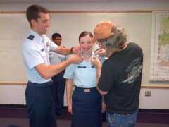 Chief Abigail Ham receives her insignia from her father and brother upon her promotion to C/CMSgt