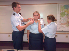 Cadet Taylor Balog receives her insignia upon her promotion to C/TSgt