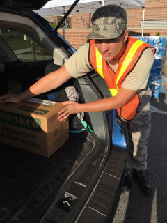 Cadet loads supplies in car