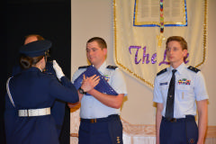 C/Capt Willis presents the flag to C/Col Waters as Gen Scanlan and C/2nd Lt Barrow looks on.