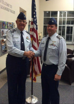 Squadron Commander Capt Anthony Green (right) congratulates CMSgt Stephen P. Madison after the promotion ceremony.