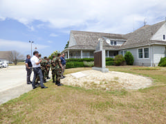 Squadron members reading the inscription on Civil Air Patrol Coastal Patrol Monument Base 16. 