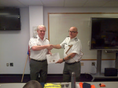 Lt McCauley receives award certificate