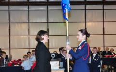 C/Capt Casey Carnes accepts the squadron flag from Lt Lee Kosub, NC052/CDC