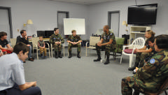 Cadets and other young adults meet with Maj Cunningham. 
