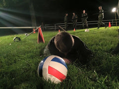 A Blindfolded Cadet Is Guided Through The Obstacle Course. 